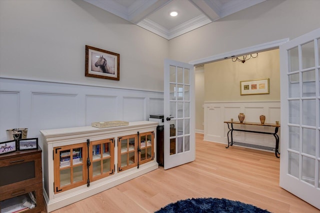 living area featuring beam ceiling, french doors, coffered ceiling, crown molding, and hardwood / wood-style floors