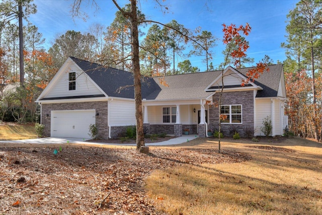 view of front of property with a garage, a porch, and a front yard