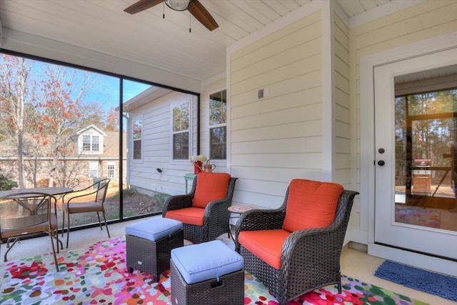 sunroom featuring ceiling fan