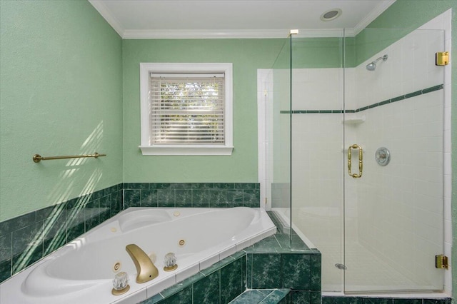 full bathroom with a jetted tub, a shower stall, and ornamental molding