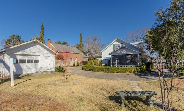 view of yard with a garage and driveway