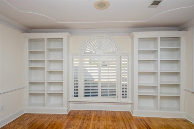 interior space featuring baseboards, wood finished floors, visible vents, and built in features