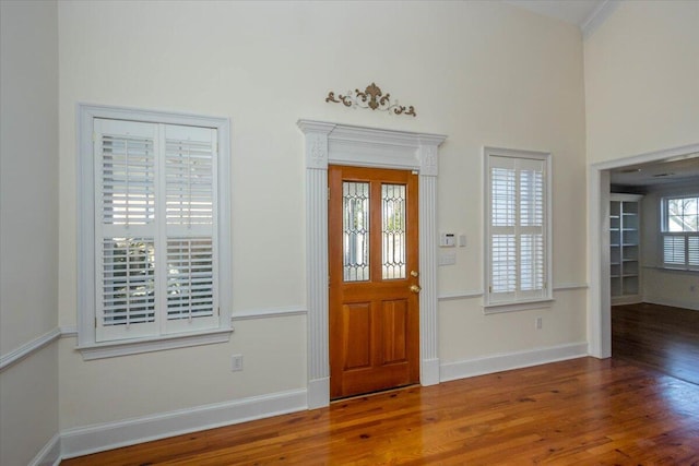 entrance foyer with baseboards and wood finished floors