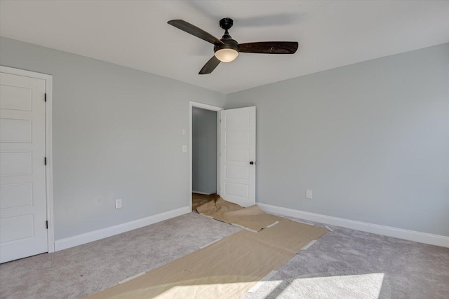 unfurnished bedroom with ceiling fan and light colored carpet