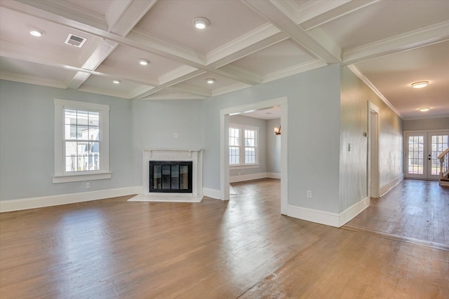 unfurnished living room featuring hardwood / wood-style flooring, crown molding, beam ceiling, and coffered ceiling