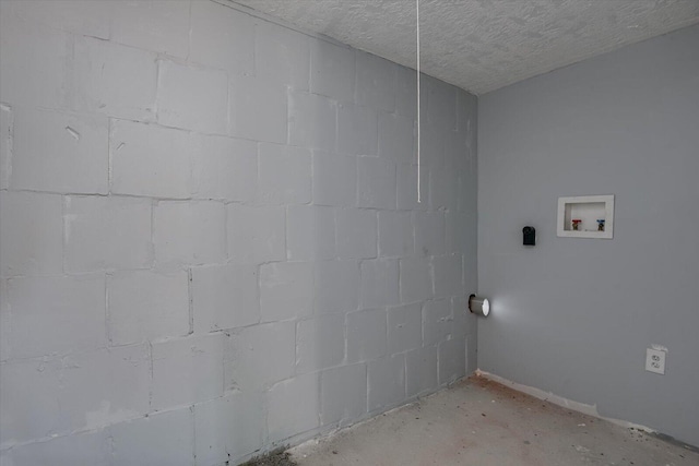 laundry area with washer hookup and a textured ceiling