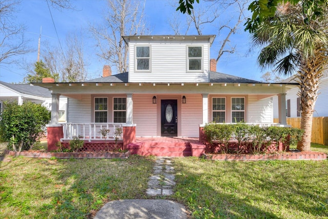 view of front facade with covered porch and a front yard