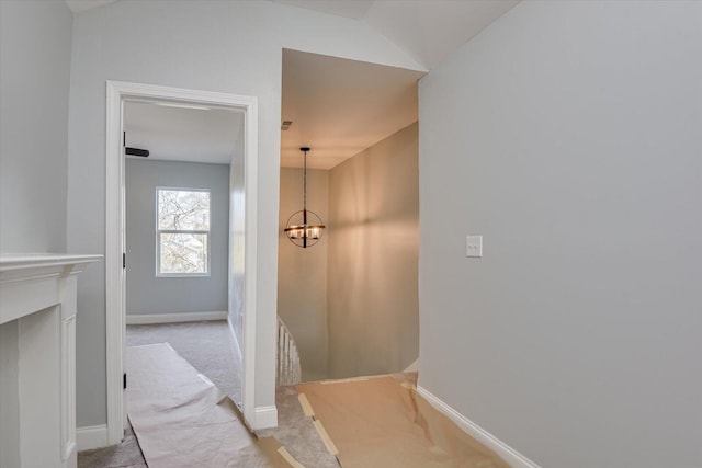 bathroom featuring a chandelier and lofted ceiling