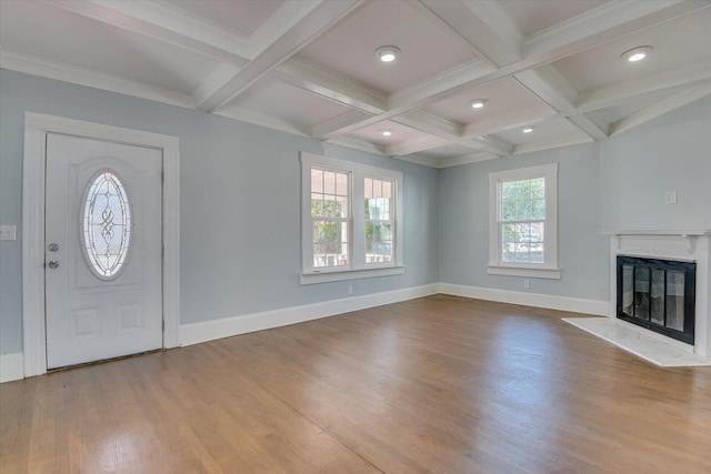 entrance foyer with coffered ceiling, a high end fireplace, beam ceiling, and wood-type flooring