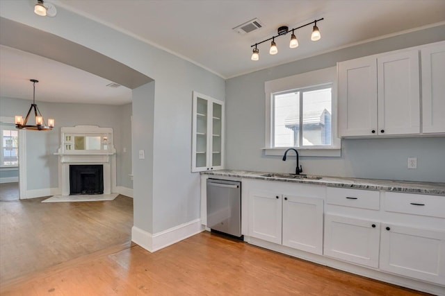 kitchen with sink, white cabinetry, and dishwasher