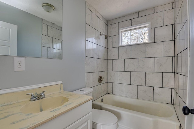 full bathroom with toilet, a textured ceiling, tiled shower / bath combo, and vanity