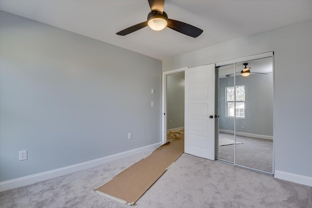 bedroom with ceiling fan, a closet, and light carpet