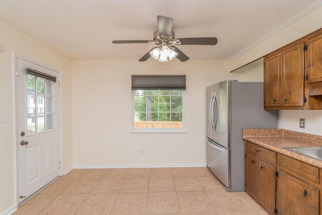2421 Castlewood Dr, Augusta, GA 30904 - kitchen featuring brown cabinets, plenty of natural light, a ceiling fan, and baseboards