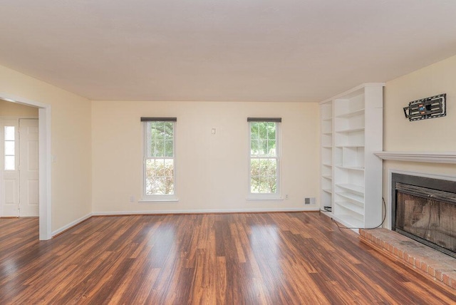 2421 Castlewood Dr, Augusta, GA 30904 - unfurnished living room with wood finished floors, a brick fireplace, baseboards, and built in features