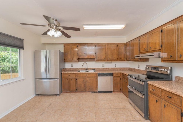 2421 Castlewood Dr, Augusta, GA 30904 - kitchen featuring appliances with stainless steel finishes, range hood, brown cabinets, a sink, and light countertops