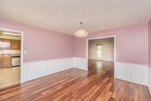 2421 Castlewood Dr, Augusta, GA 30904 - unfurnished room with wood finished floors, a wainscoted wall, a sink, and a chandelier