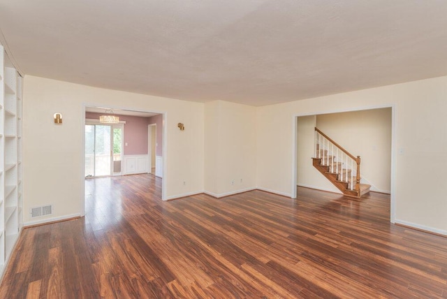 2421 Castlewood Dr, Augusta, GA 30904 - unfurnished room featuring wood finished floors, stairs, a chandelier, and baseboards