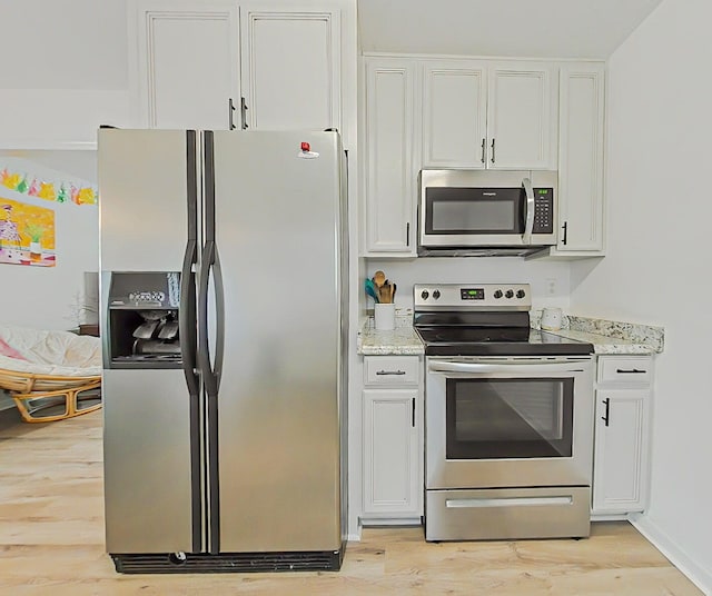 15 Whitney Ct, Augusta, GA 30904 - kitchen featuring appliances with stainless steel finishes, light wood-type flooring, white cabinets, and light stone counters