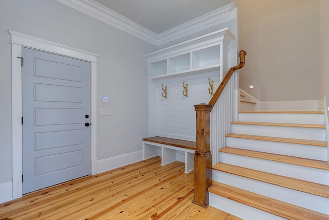 mudroom with light wood-type flooring and crown molding