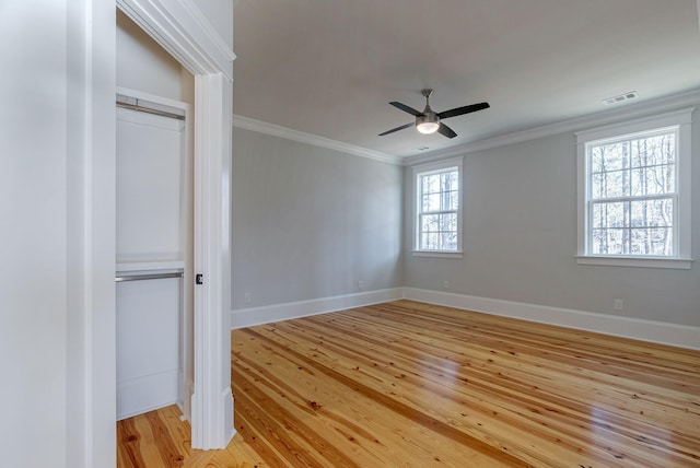 unfurnished bedroom featuring a closet, light hardwood / wood-style flooring, ceiling fan, and ornamental molding