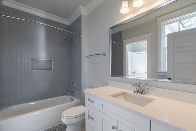 full bathroom with tile patterned floors, ornamental molding, vanity, tiled shower / bath combo, and toilet