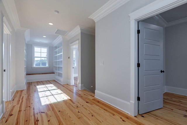 interior space with built in shelves, crown molding, and light hardwood / wood-style flooring