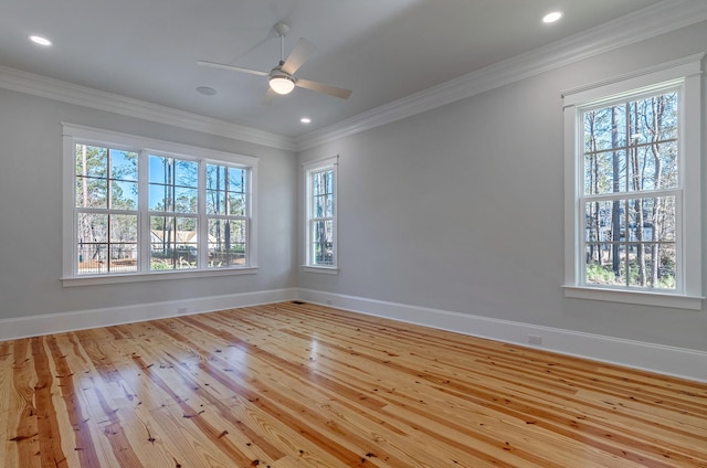 empty room featuring ceiling fan, light hardwood / wood-style flooring, and ornamental molding