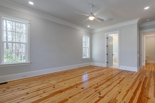 spare room featuring light hardwood / wood-style floors, plenty of natural light, ornamental molding, and ceiling fan