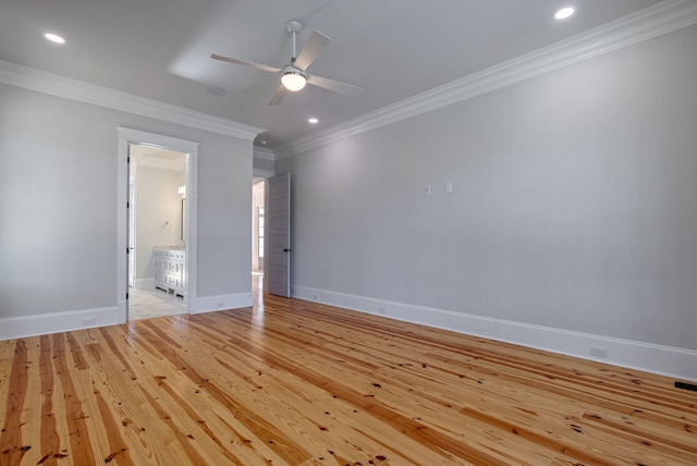 spare room featuring light wood-type flooring, ceiling fan, and ornamental molding