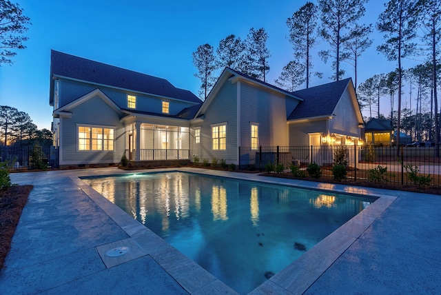 pool at dusk featuring a patio area