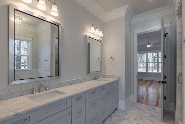 bathroom with wood-type flooring, vanity, ceiling fan, and ornamental molding