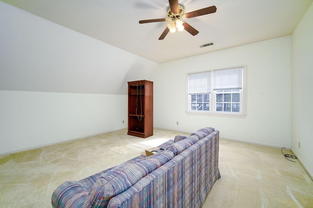 sitting room featuring ceiling fan, vaulted ceiling, and light carpet