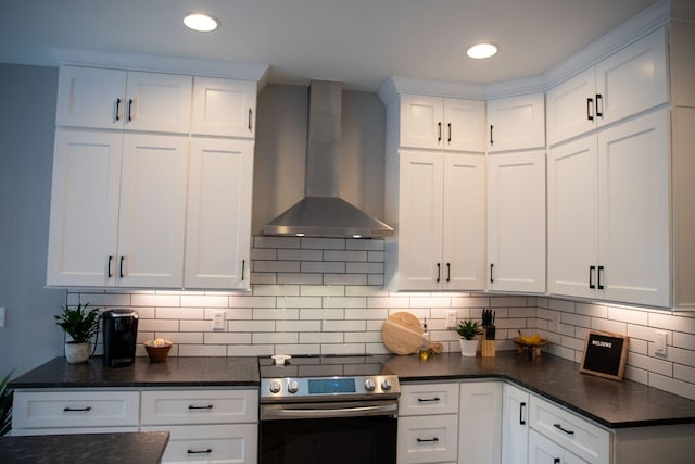 216 Sumter Ln, Mccormick, SC 29835 - kitchen featuring wall chimney range hood, stainless steel electric stove, white cabinets, backsplash, and recessed lighting