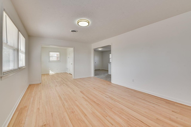 empty room featuring light hardwood / wood-style floors and a textured ceiling