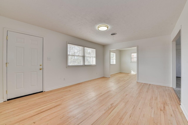 interior space featuring light hardwood / wood-style floors and a textured ceiling