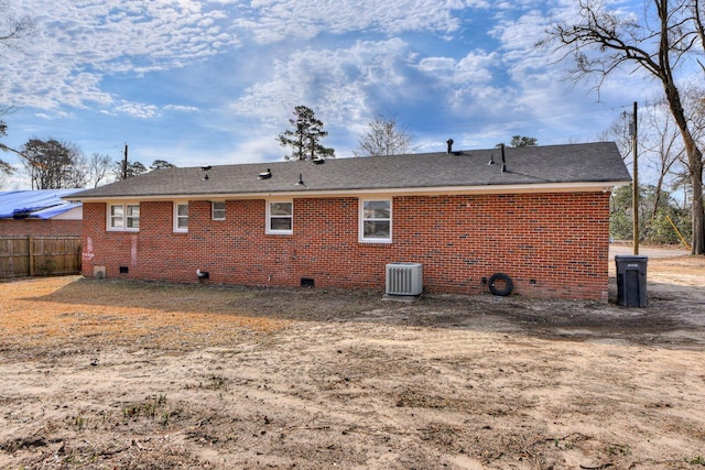 back of house with central AC unit