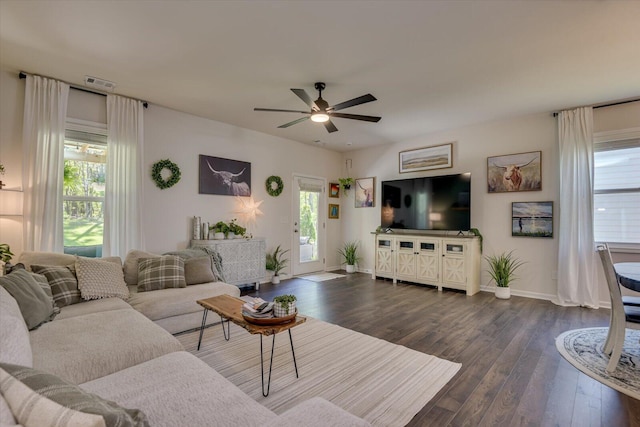 living area with ceiling fan, visible vents, dark wood-style floors, and baseboards