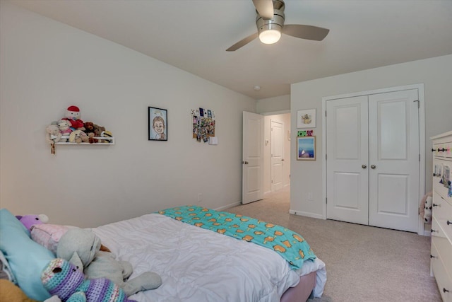 bedroom with a closet, ceiling fan, carpet, and baseboards