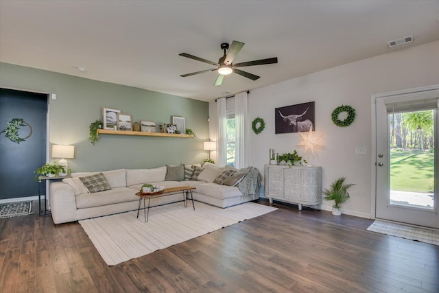 living room with wood finished floors, visible vents, plenty of natural light, and a ceiling fan