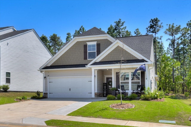 craftsman-style home featuring a porch, a front lawn, a shingled roof, a garage, and driveway