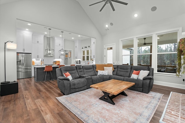 living room with dark wood-type flooring, high vaulted ceiling, and ceiling fan