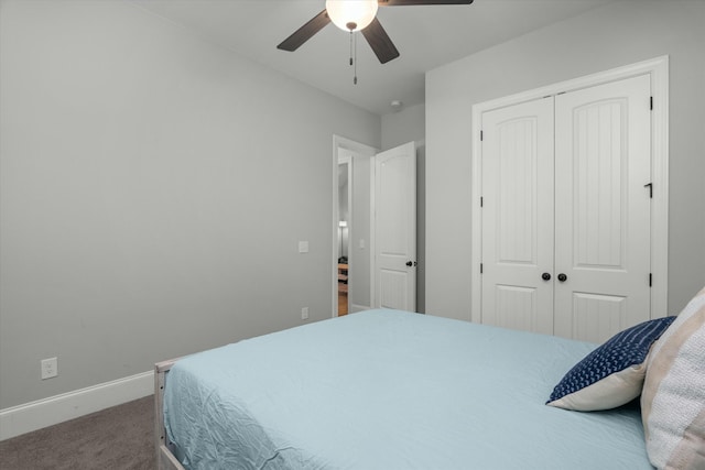 carpeted bedroom with ceiling fan and a closet