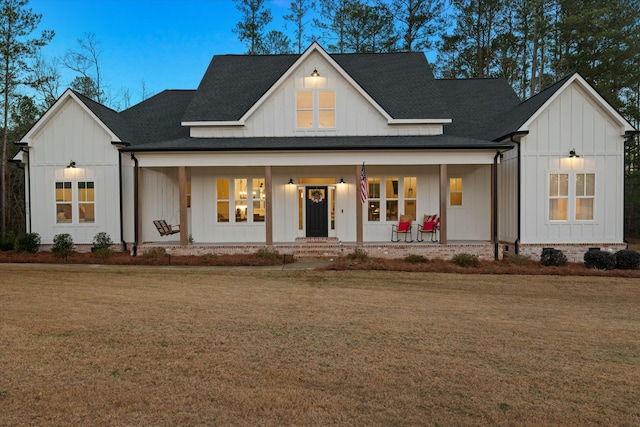 modern farmhouse style home with a yard and a porch