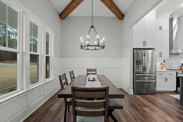 dining room featuring dark wood-type flooring, beam ceiling, and an inviting chandelier