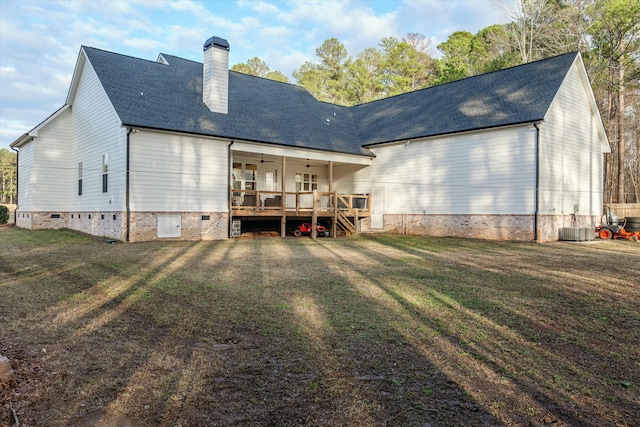 rear view of property featuring a yard, ceiling fan, and a deck