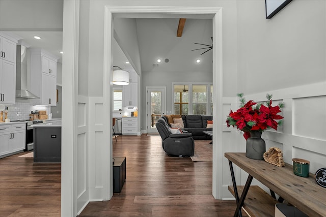 interior space featuring beam ceiling, high vaulted ceiling, and dark hardwood / wood-style flooring