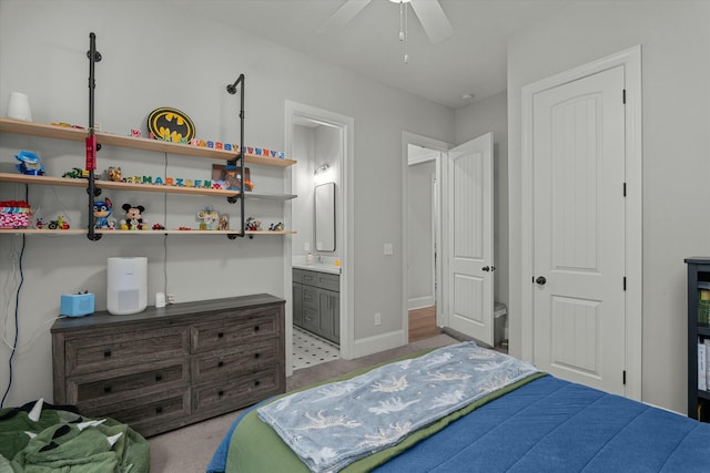 carpeted bedroom featuring ceiling fan and connected bathroom