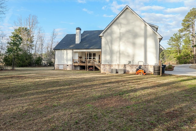 back of property with a yard and a porch