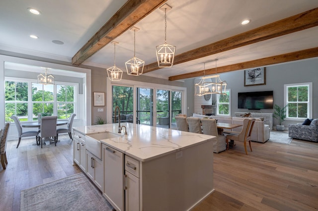 188 Lagoon Dr, Clarks Hill, SC 29821 - kitchen featuring a chandelier, beam ceiling, white cabinetry, open floor plan, and wood finished floors