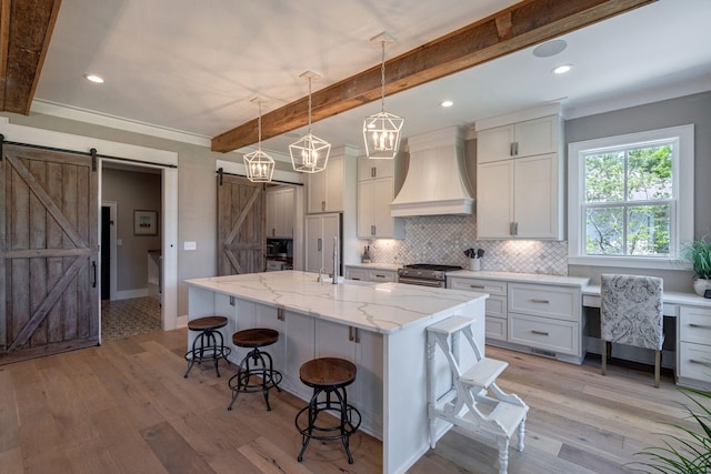 188 Lagoon Dr, Clarks Hill, SC 29821 - kitchen featuring a barn door, premium range hood, beamed ceiling, backsplash, and light wood finished floors